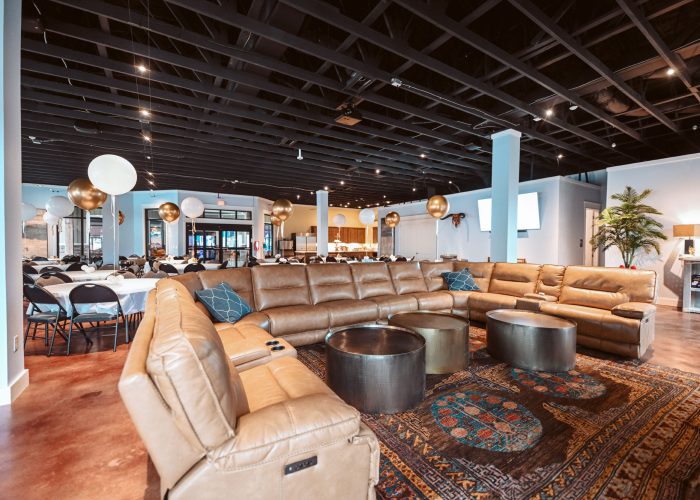 Elegant event lounge at Splash RV Resort in Milton, Florida with leather sectional seating and celebratory balloon arrangements